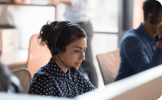 a support tech sitting at a computer with a headset on