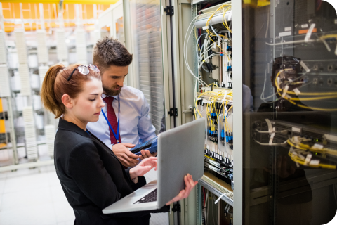 Two workers in a server room