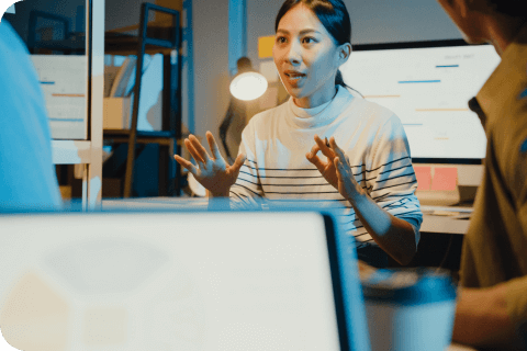 a young woman discussing a project with coworkers