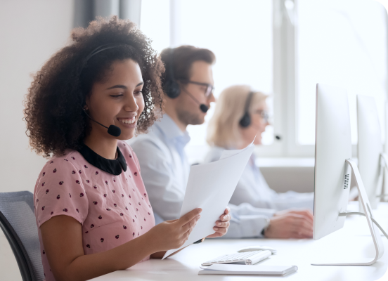 a lady sitting at a desk with a headset on