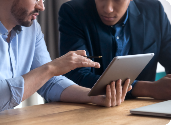 Two men looking at a tablet