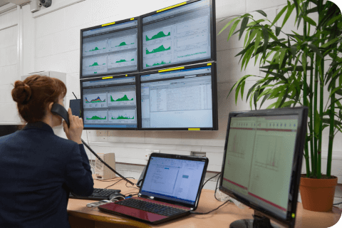 Technician sitting in office running diagnostics in large data center